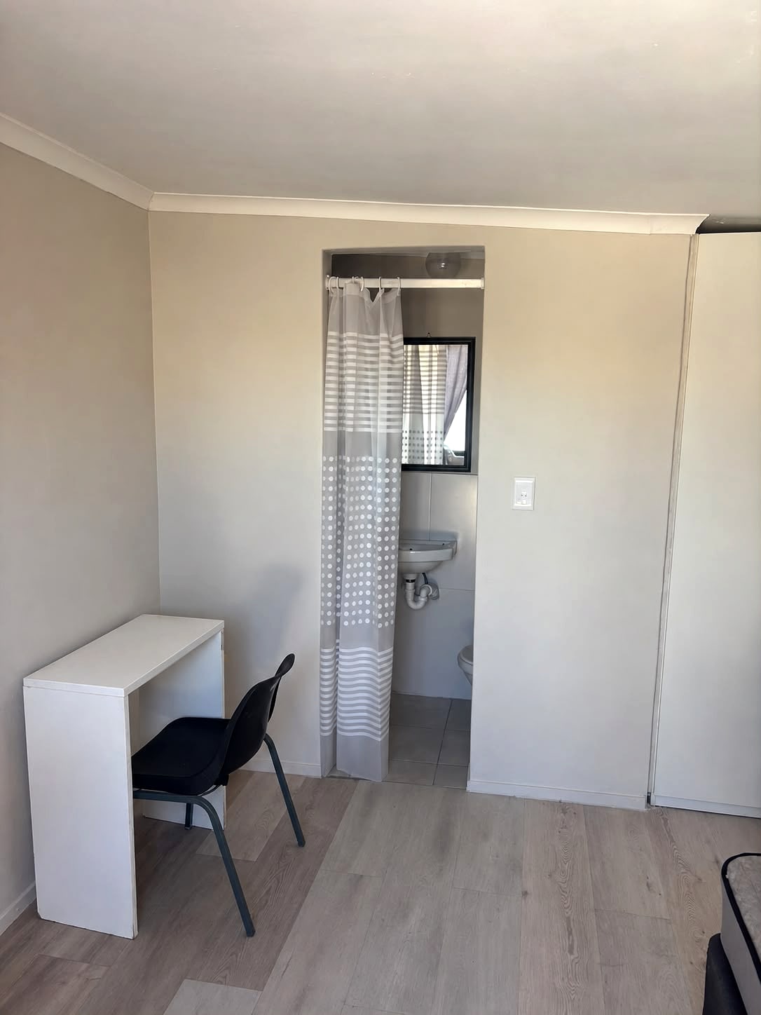 A 12A room with a desk, a microwave and its own shower
