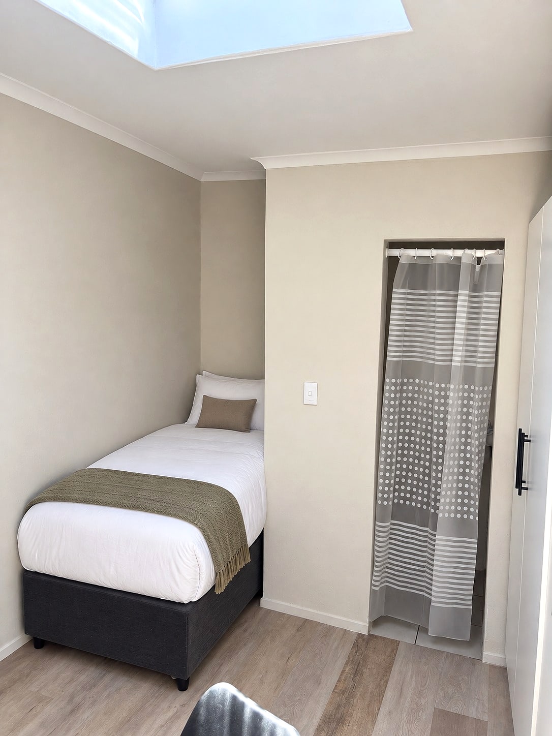 A private single room at 12B with a skylight and its own shower